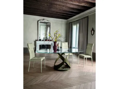 Tavolo rotondo con struttura in metallo e base in marmo con top in vetro di Tonin Casa